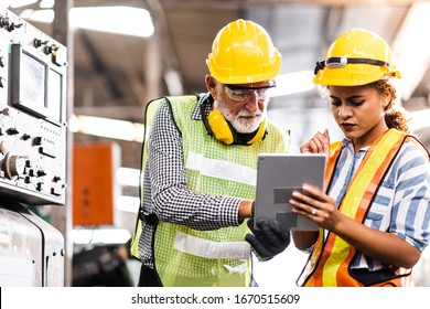 Industrial Engineers in Hard Hats.Work at the Heavy Industry Manufacturing Factory.industrial worker indoors in factory.aged man working in an industrial factory. - Powered by Shutterstock