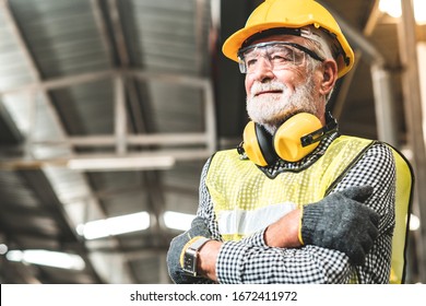 Industrial Engineers in Hard Hats.Work at the Heavy Industry Manufacturing Factory.industrial worker indoors in factory.aged man working in an industrial factory. - Powered by Shutterstock