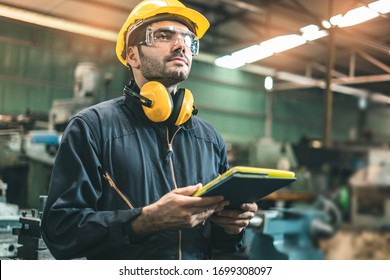 Industrial Engineers In Hard Hats.Work At The Heavy Industry Manufacturing Factory.industrial Worker Indoors In Factory. Man Working In An Industrial Factory.Safety First Concept.