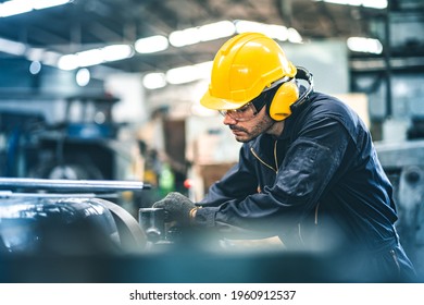 Industrial Engineers in Hard Hats.Work at the Heavy Industry Manufacturing Factory.industrial worker indoors in factory. man working in an industrial factory.Safety first concept. - Powered by Shutterstock