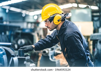 Industrial Engineers in Hard Hats.Work at the Heavy Industry Manufacturing Factory.industrial worker indoors in factory. man working in an industrial factory.Safety first concept. - Shutterstock ID 1964592124