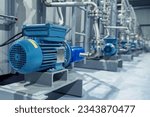 Industrial equipment. New blue electric motors with pumps on the stainless steel production line. Industrial background.. Additive pump station in petrochemical technology.