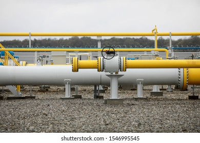 Industrial equipment (pipes, manometer/pressure gauge, levers, faucets, indicators) in a natural gas compressor station.