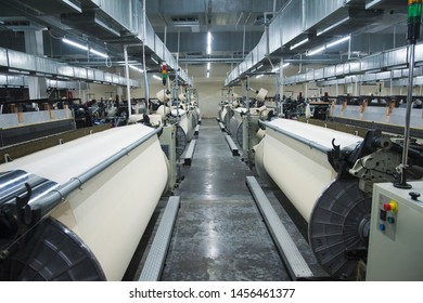 Industrial fabric production line. Weaving looms at a textile factory