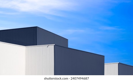 Industrial Factory Buildings with black and white Aluminium Metal Exterior Wall in Modern Minimal style against Blue Sky Background, Perspective side view - Powered by Shutterstock