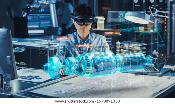 Industrial Factory Chief Engineer Wearing AR\
Headset Designs a Prototype of an Electric Motor on the Holographic\
Projection Blueprint. Futuristic Virtual Design of Mixed Technology\
Application.