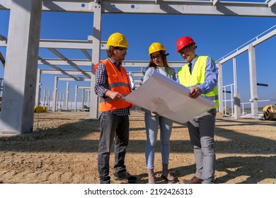 Industrial And Factory Construction And Project Management. Supervisor, Female Architect And Construction Foreman Having Conversation At Workplace. Project Management And Field Crew Meeting.