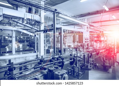 Industrial factory equipment in blue color with red light, conveyor line and steel tools, industry background, toned - Powered by Shutterstock