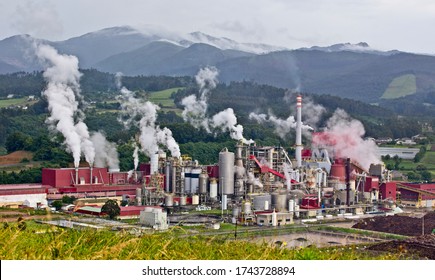 Industrial factory (paper mill) steaming away on the outskirts of Navia, Asturias, Spain.