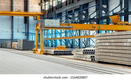 Industrial Factory For Production Of Floor Slabs Stacked In Pile In Workshop With Automated Equipment And Overhead Yellow Crane Beam, Warehouse Of Prefabricated Reinforced Concrete Structures.