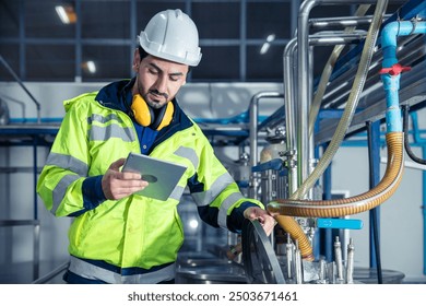 Industrial factory worker, Engineer staff working in food and drinks factory, Control check quality condition of liquid pipe supply in plant. - Powered by Shutterstock