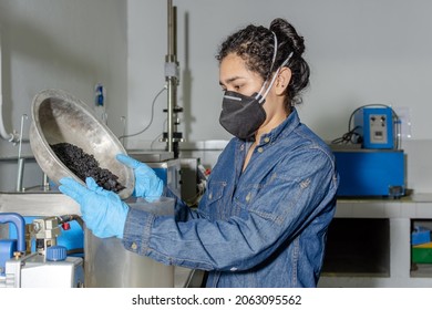 Industrial female worker with protective mask and latex gloves, testing asphalt in geological laboratory - Shutterstock ID 2063095562