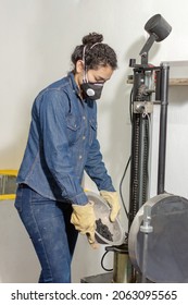 Industrial female worker with protective mask and leather gloves, testing asphalt in geological laboratory