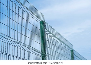 Industrial Fencing Made Of Heavy Duty Metal Wire On A Background Blue Sky