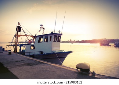 Industrial Fishing Boat Is Moored In Port. Vintage Toned Photo