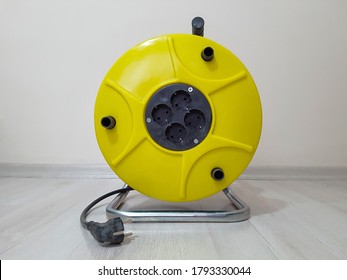 Industrial Four Socket Extension Cable Reel 50 Meters Long On Parquet Floor