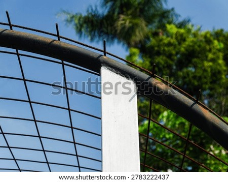 The industrial geometric composition featuring circular black steel pipes and latticework, joined by white metal poles highlights the connection between metalwork and outdoor design.