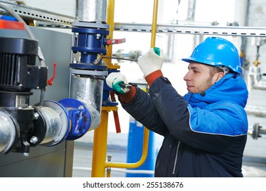 Industrial Heat Engineer Worker Plumber At Boiler Room Installation