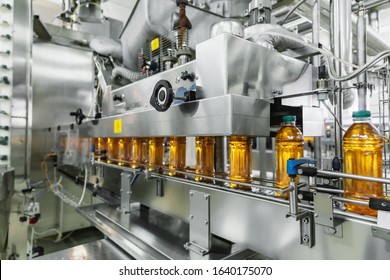 Industrial Interior Of Natural Juice Plant Production. Conveyor Belt, Filled Bottles On Beverage Factory, Industry Production Line.