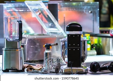 Industrial Kitchen Appliances. Food Processor For Cooking Large Amounts Of Food. Restaurant Kitchen Equipment. Food Processor On The Background Of The Stove And Dishwasher. Cook's Job.