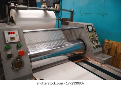 Industrial Laminator, Lamination Of Paper Products. The Manufacture Of Packaging. Outdated Equipment. Company. Place For Text.