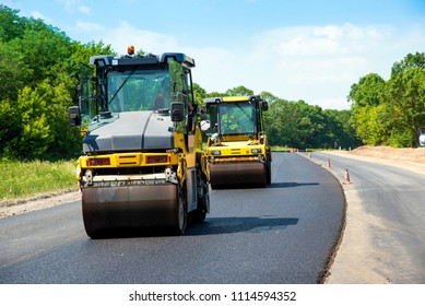 industrial landscape with rollers that rolls a new asphalt on the road. Repair work, complicated transport movement. - Shutterstock ID 1114594352