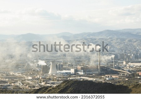The industrial landscape with smoke billowing from factory chimneys