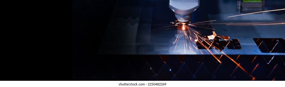 Industrial laser cut machine while cutting the sheet metal with the sparking light.copy space	 - Shutterstock ID 2250482269