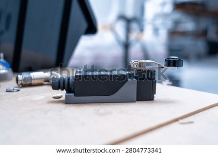 Industrial Limit Switch Component with Roller Lever in Automation Workshop Close-Up