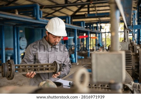 Industrial Maintenance Engineer Checking Pump Impeller for Reliable Plant Operation