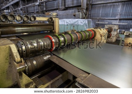 Industrial metal rolling machine processing steel sheet in factory