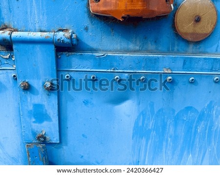 Industrial metal weathered blue paint, rivets, or and and yellow reflectors