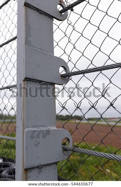 Industrial\
metallic fence on car racing speed\
track