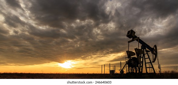 Industrial Oil And Gas Well Pump At Sunset