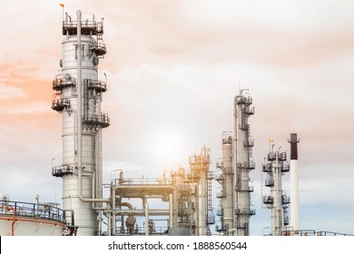 Industrial of oil refinery plant from industry zone ,Refinery factory oil storage tank and pipeline steel with sunset sky. - Shutterstock ID 1888560544