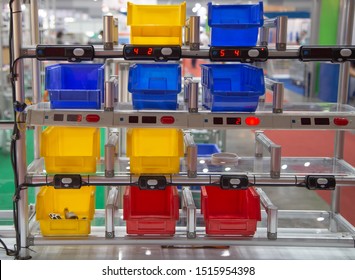 Industrial open plastic bin rack for component parts in warehouse factory - Powered by Shutterstock