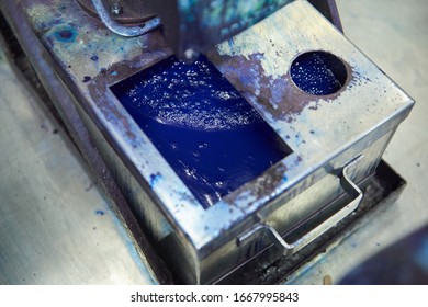 An Industrial Paint And Colour Mixing Machine Mixing Paint In An Industrial Machine. Paint Sliding And Dripping Into Metal Containers In A Colour Mixing And Making Factory