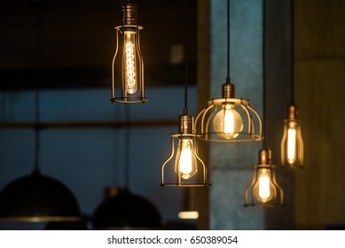 Industrial pendant lamps against rough wall. Loft interior. Edison bulbs. - Powered by Shutterstock