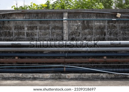 Industrial pipe system installed on cement wall