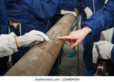 Industrial Pipeline. Composite Repair Using Fiberglass, Kevlar, Carbon, Epoxy Resin. Worker Points The Finger To The Problem. Photographed In Ukraine, Kiev Region. Color Image