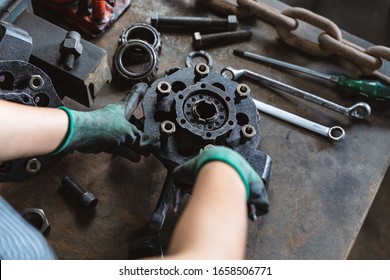 Industrial Plant Worker Repairing Car Parts In Auto Repair Workshop - Mechanical Engineer Inspecting And Adjusting Vehicle Part - Manufacturing Factory, Student Apprentice And Skilled Work Concept