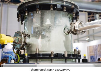 Industrial pneumatic conveying system for bulk solids. Transparent container for collecting plastic granules. Various pipelines are connected to the tank. - Shutterstock ID 1530289790