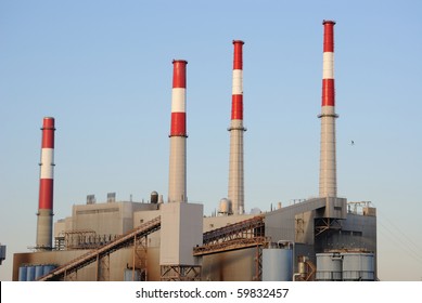 An Industrial Power Plant With Tall Smoke Stacks.