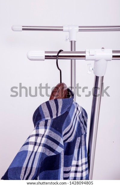 Industrial Product Interior Decoration Home\
Supplies Metal Clothes Hanging On Plastic Hanger Detail Macro Shot\
On White Background.