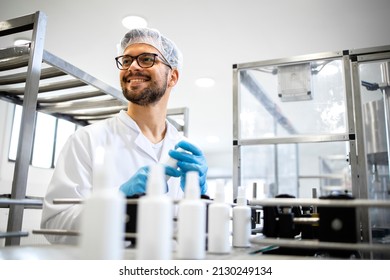 Industrial Production Of Spray Bottle Hand Sanitizer And Disinfection Chemicals. Portrait Of Technologist Worker And Spray Bottles Disinfectant In Line Moving On Conveyor Belt Machine.