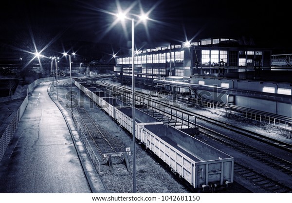 Industrial rail yard
shunting station at night with many lights and wagons on a siding
in an industrial
plant