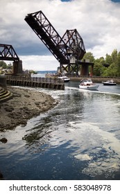 Industrial   recreational marine waterway and cantilever train draw bridge over Seattle Ballard Locks and motor boats   shore scene