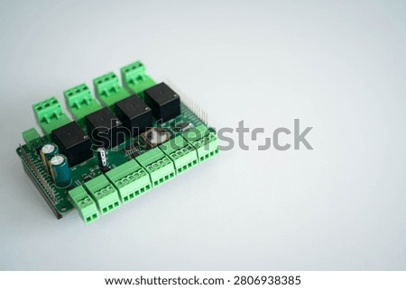 Industrial relay controller board isolated on a white background with copy space, featuring terminal block connectors for IoT, industrial automation, embedded systems, electronics engineering, smart control and hardware technology.