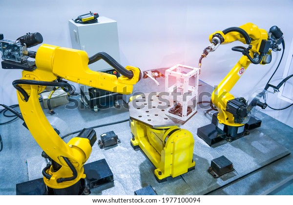  Industrial robotic\
welders arms weld the car part on factory on manufacture of the\
Assembly line