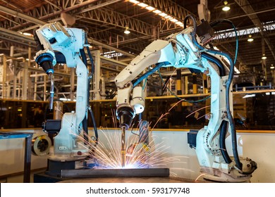 Industrial Robots Are Welding Automotive Part In Car Factory